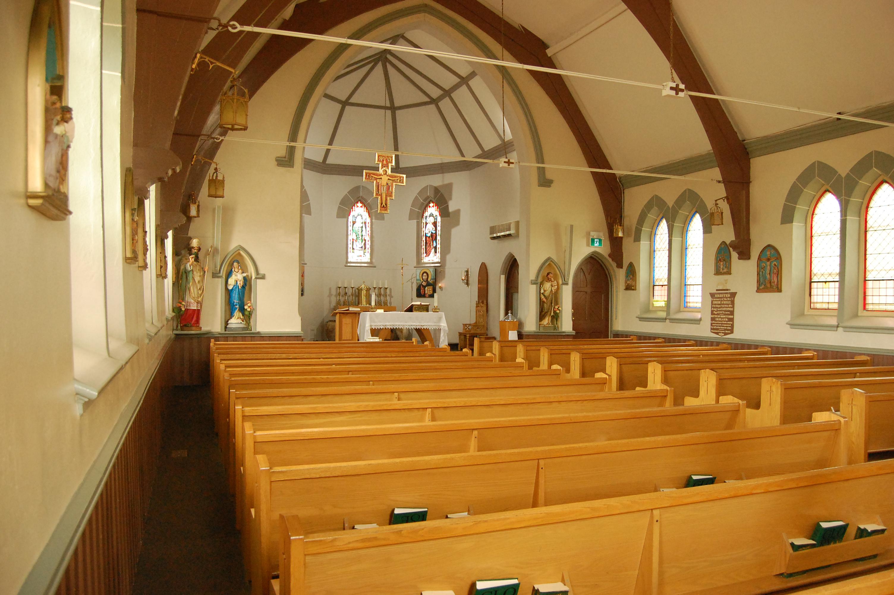 Image of inside Saint Patrick's Church with green tape to identify where people can sit during a pandemic